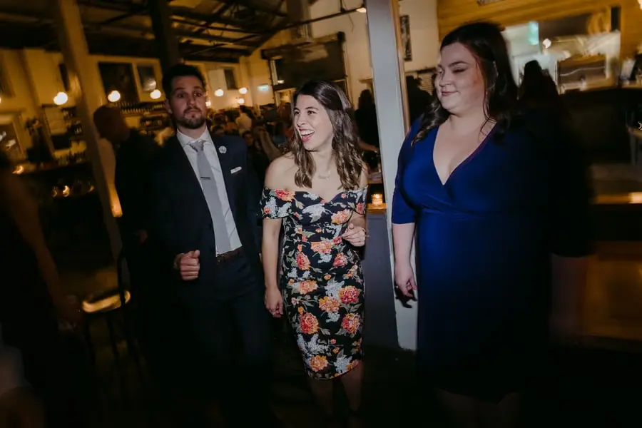 Three guests posing together on the dance floor