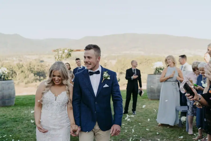 Newlyweds walking hand in hand after the ceremony