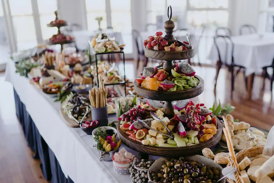 Colourful fruit and savoury platters arranged on tiered serving stands