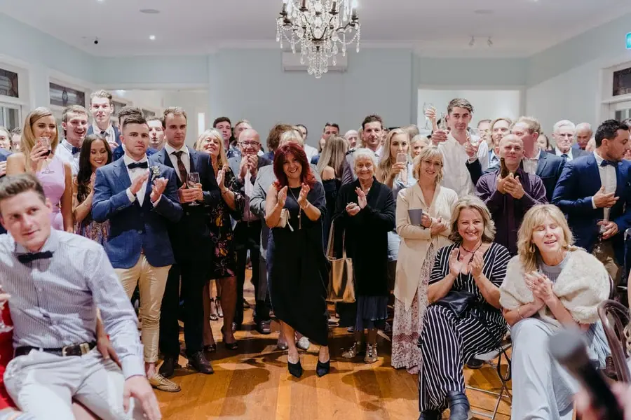 Guests laughing and applauding together in the reception room