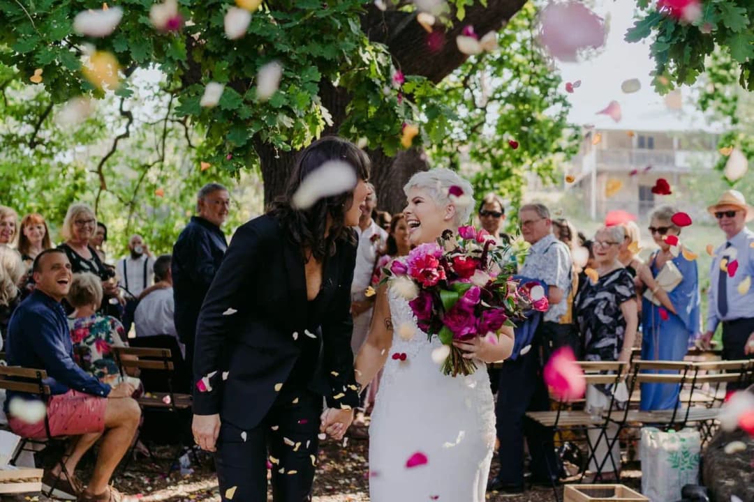 Couple walking together through falling flower petals