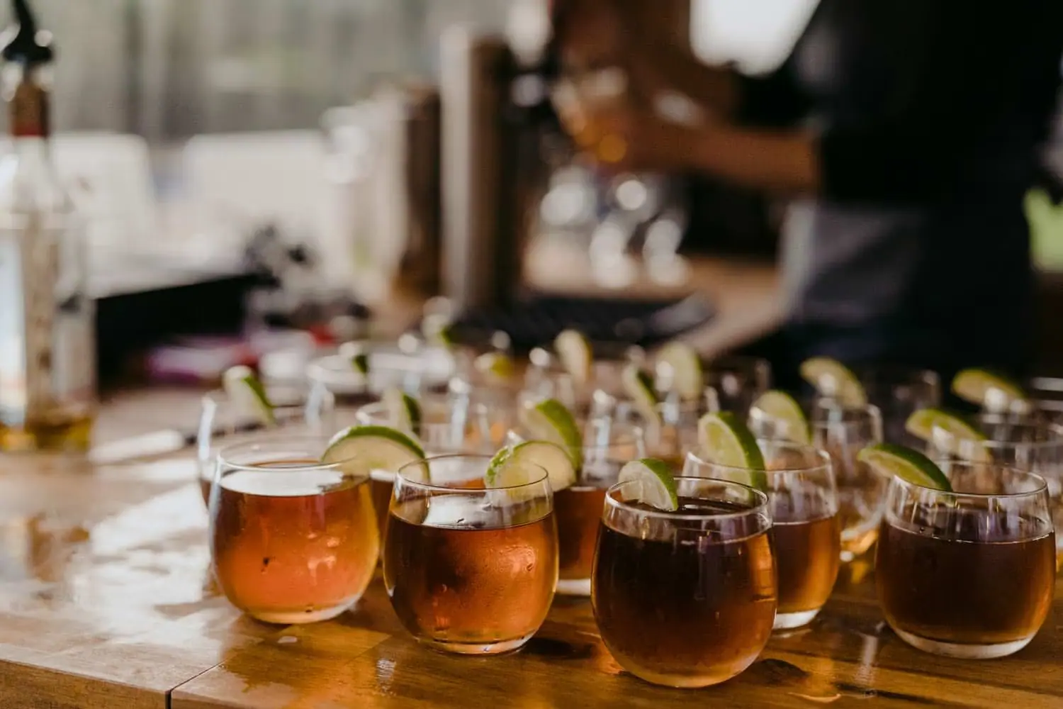 Rows of drinks garnished with lime beside the reception table