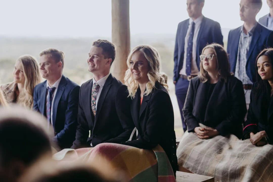 Seated guests smiling during the wedding ceremony
