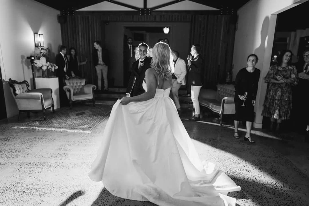 Black and white photograph of the bride twirling on the dance floor