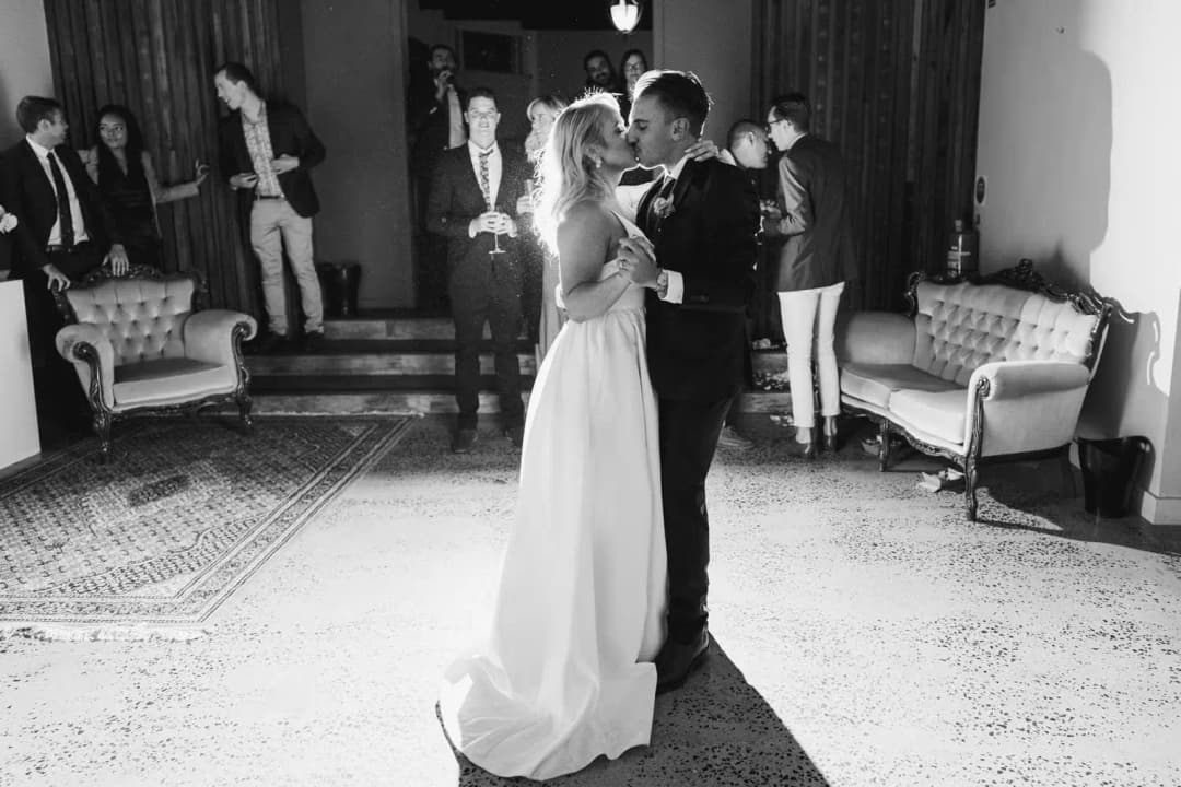 Black and white photograph of the couple dancing with her arm raised