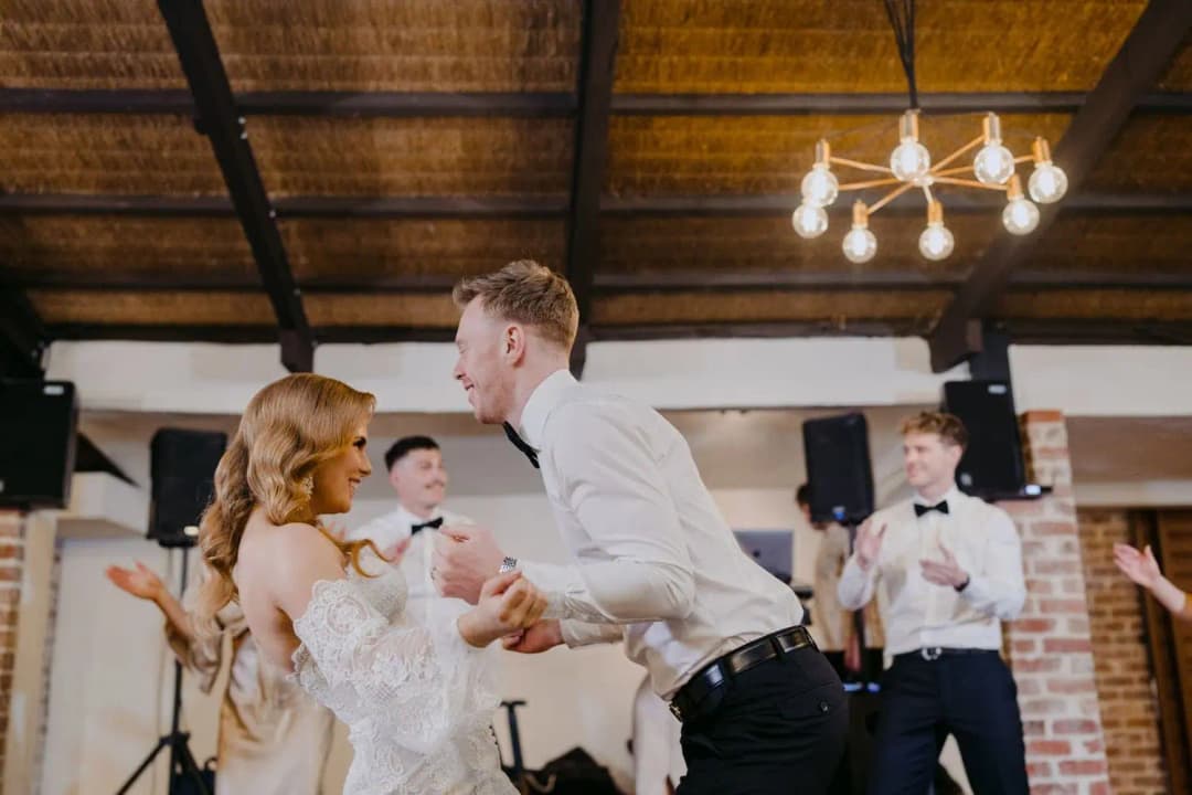 Bride and groom smiling together during their first dance