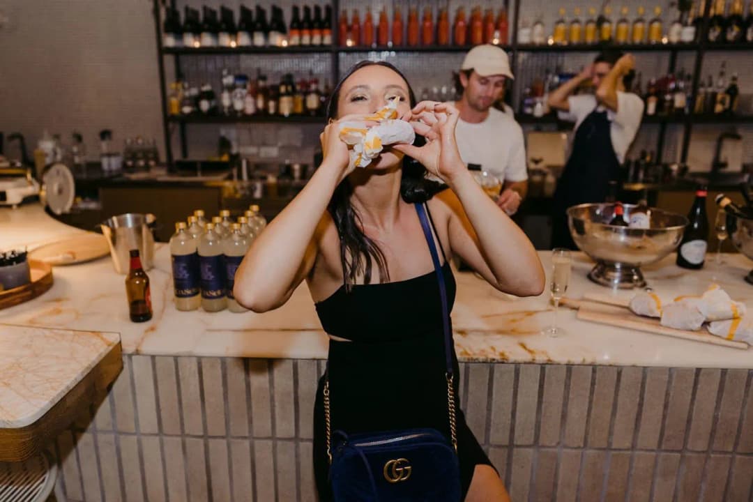 Guest eating a burger beside the indoor bar