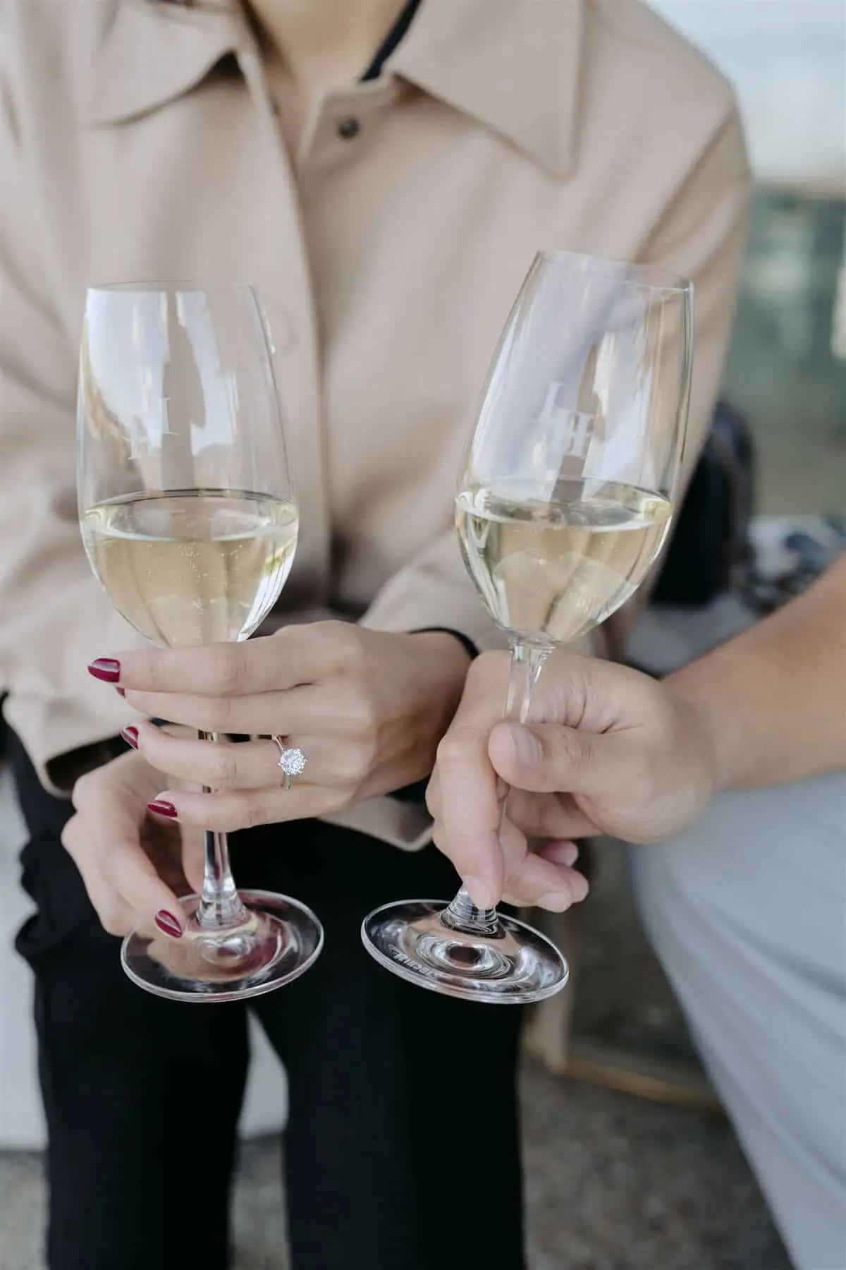 Two sparkling wine glasses held together in a celebratory toast.