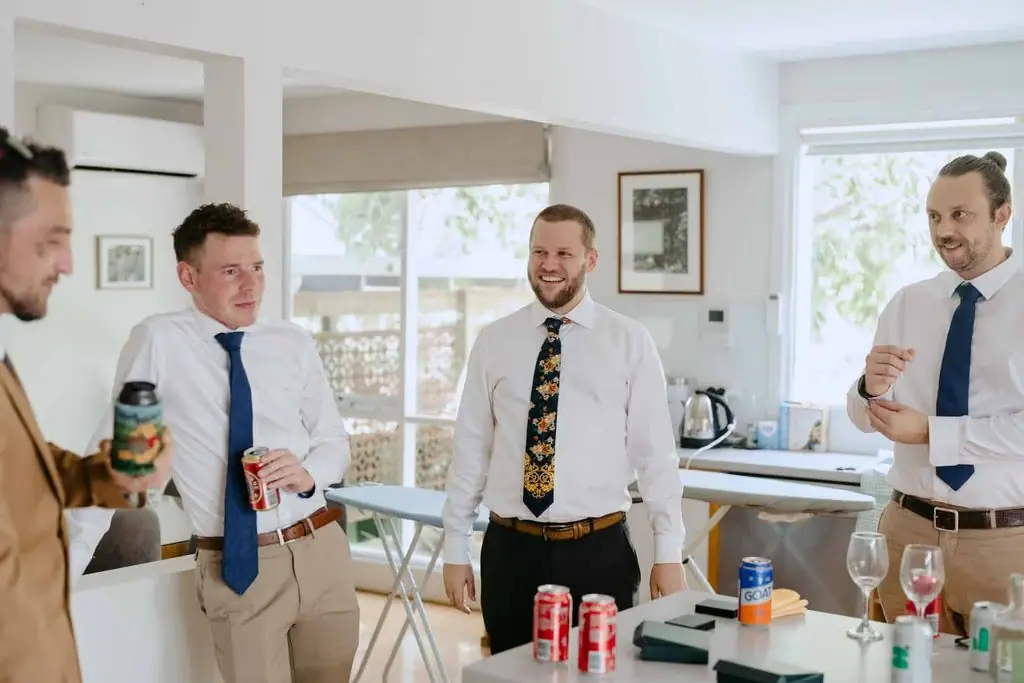 Groomsmen chatting around a table