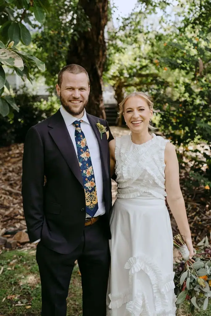 Couple posing together in a garden