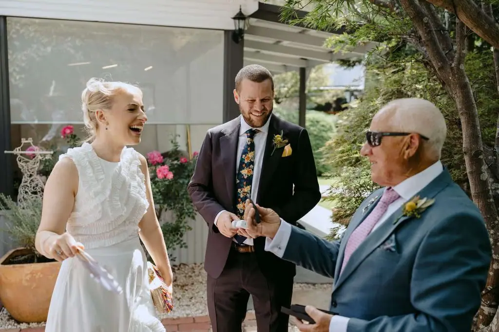 Couple talking with a guest outside the venue