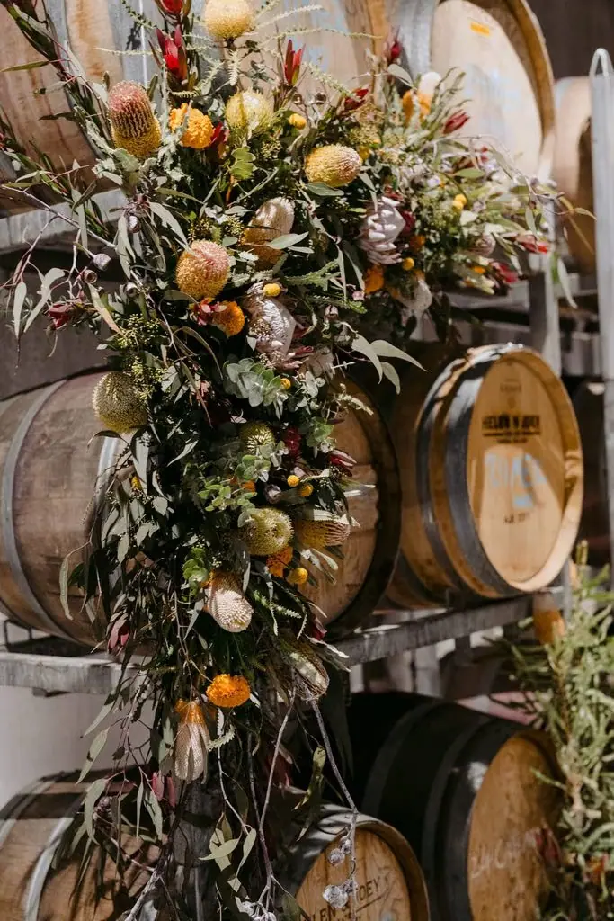 Close-up of flowers and foliage decorating wine barrels