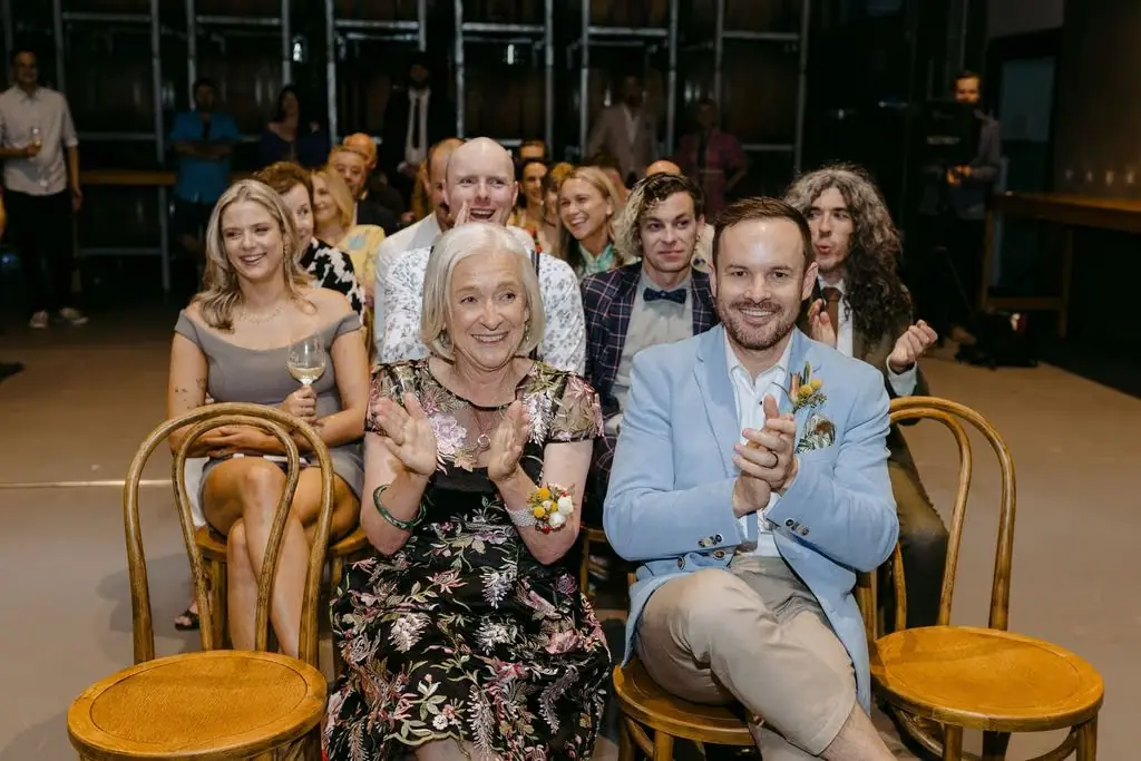 Guests smiling while seated in the barrel room