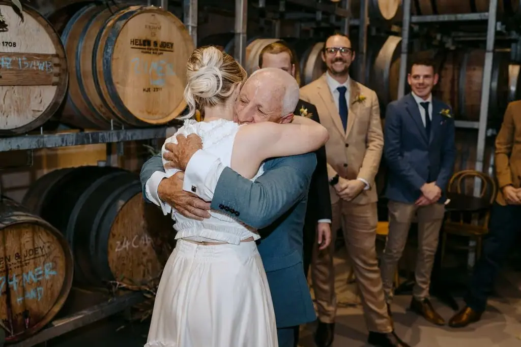 Bride embracing an older guest at the ceremony