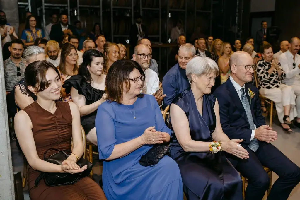 Guests seated and watching the indoor ceremony