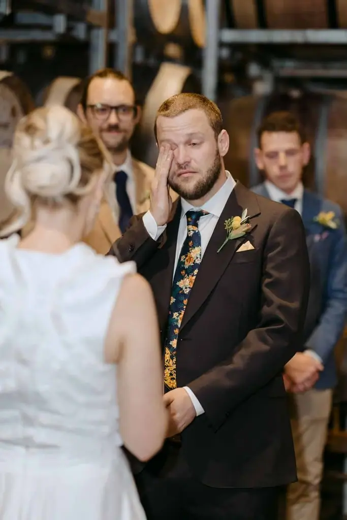 Groom smiling at the bride during their ceremony
