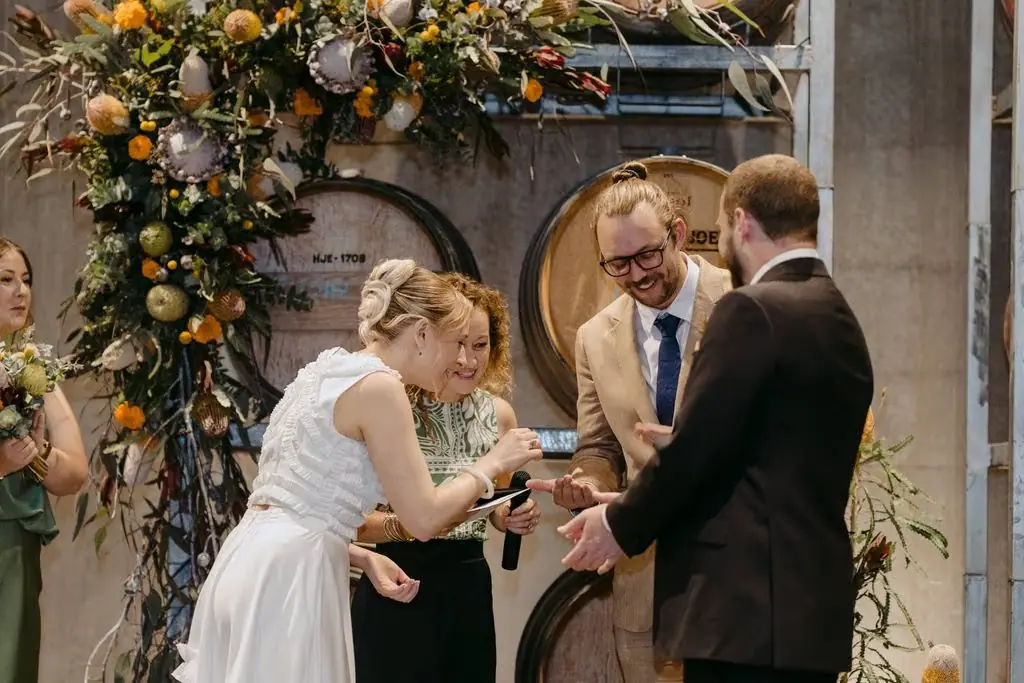 Bride looking down as the couple exchange rings