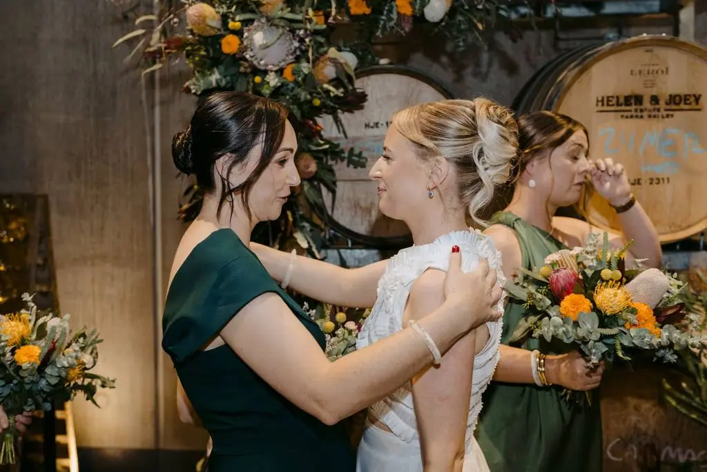 Bride embracing a bridesmaid after the ceremony