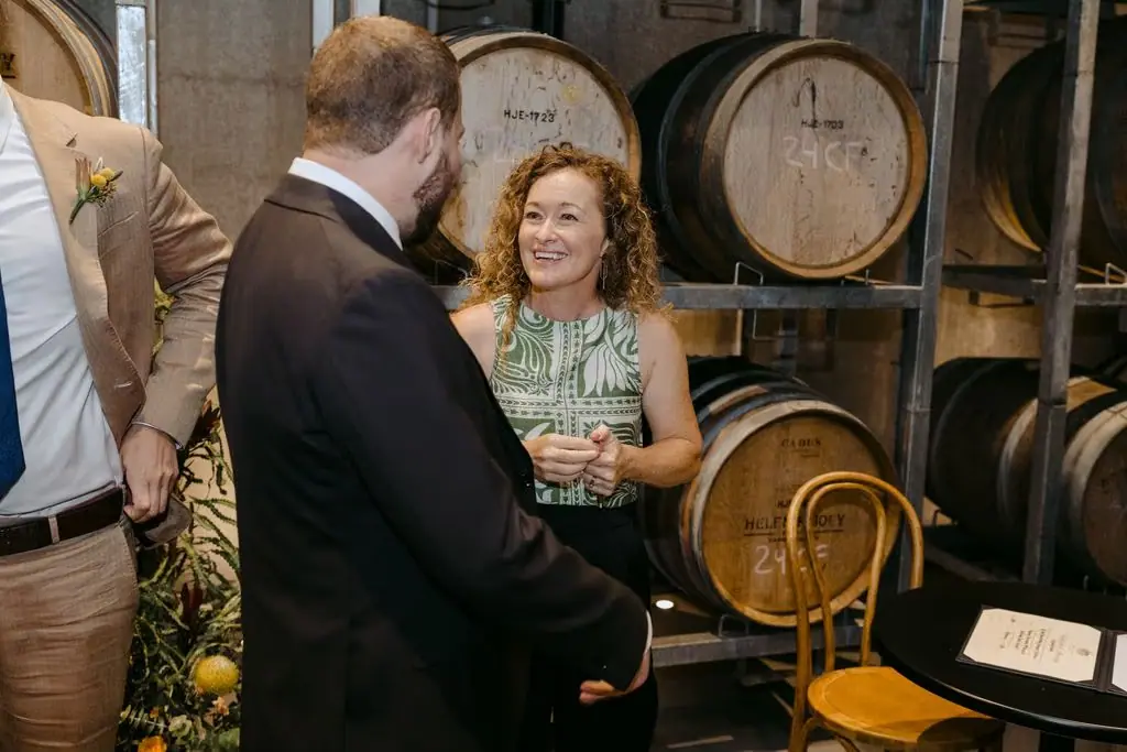 Bride smiling at the groom while seated for the register signing