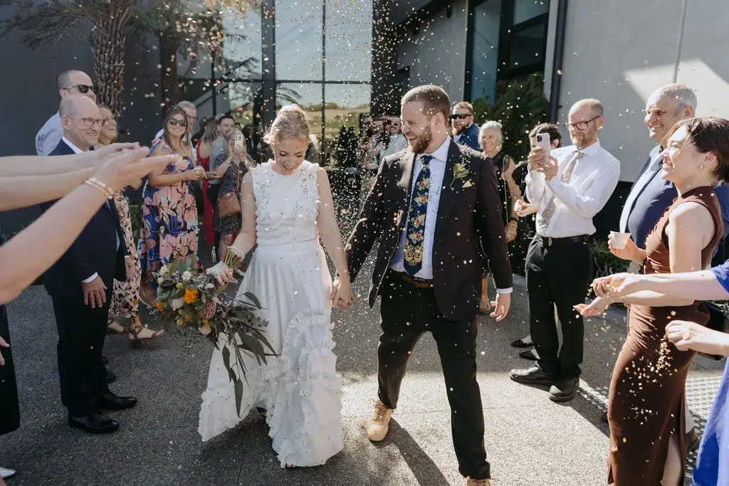 Guests cheering as the couple walk outside