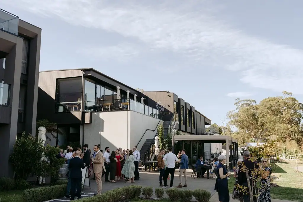 Guests mingling outside the modern wedding venue
