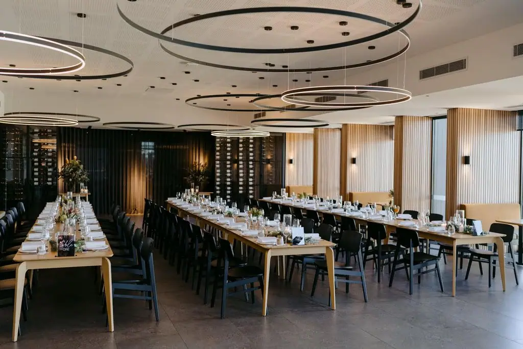 Wide view of the dining room set for a wedding reception