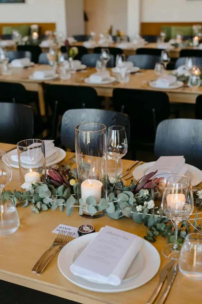 Close-up of place settings and floral centrepieces