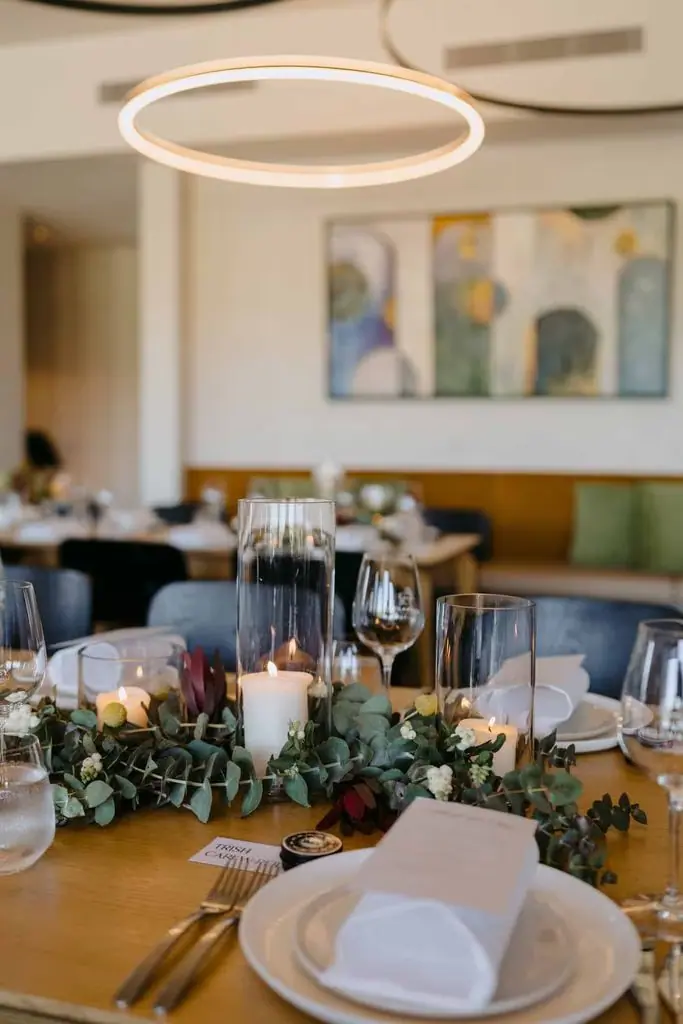Reception tables beneath circular pendant lights