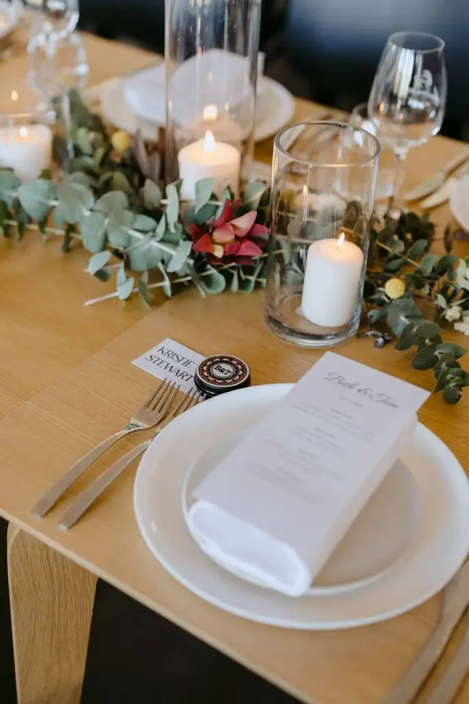 Place setting with a folded napkin, flowers and glassware