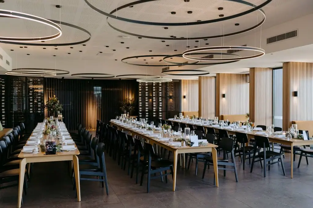 Wide view of reception tables and floor-to-ceiling windows
