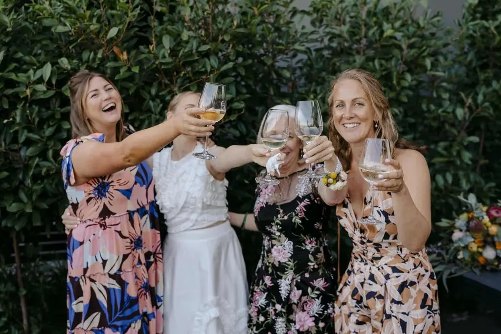 Guests smiling and raising their glasses in a garden