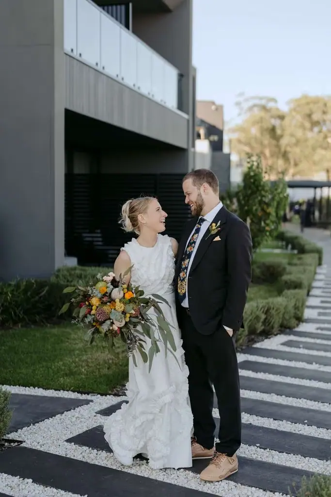 Couple standing together outside the modern venue