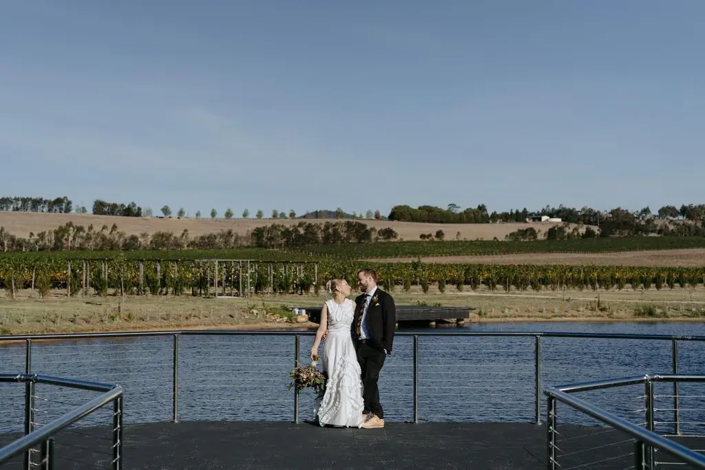 Couple embracing on a jetty beside the lake