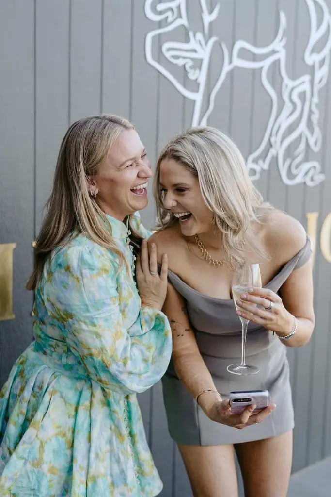 Bride chatting with a guest outside the venue