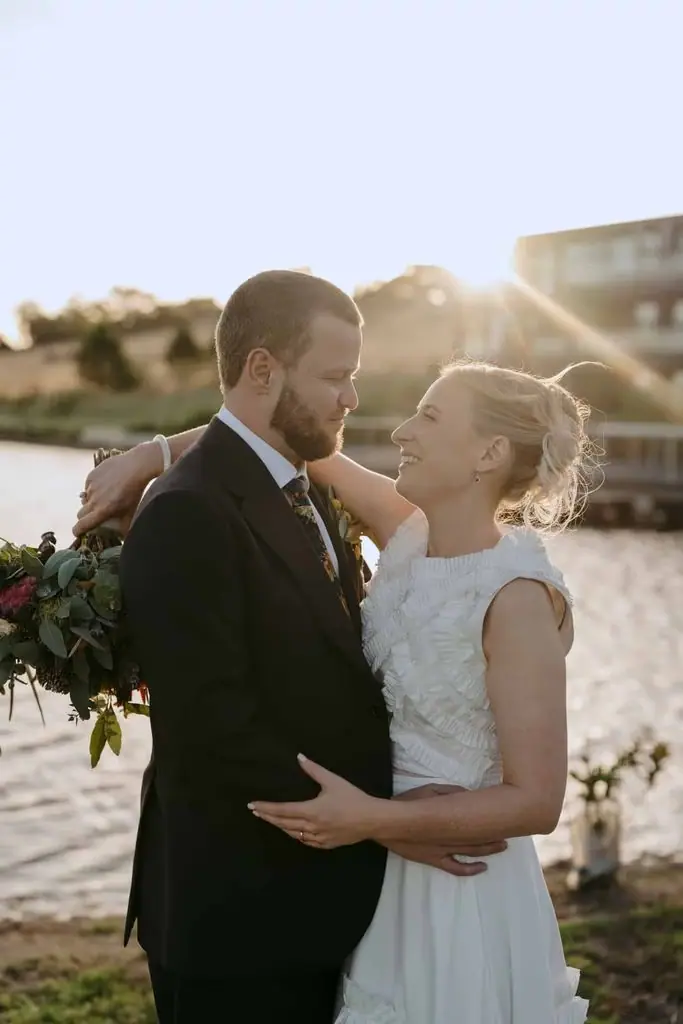 Couple facing each other beside the lake in evening light