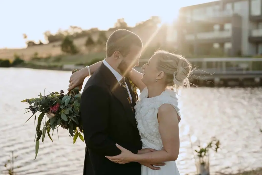 Couple touching foreheads beside the lake
