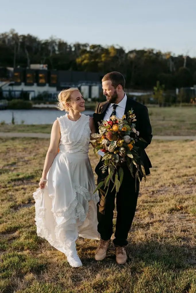 Couple holding hands on a lakeside walk