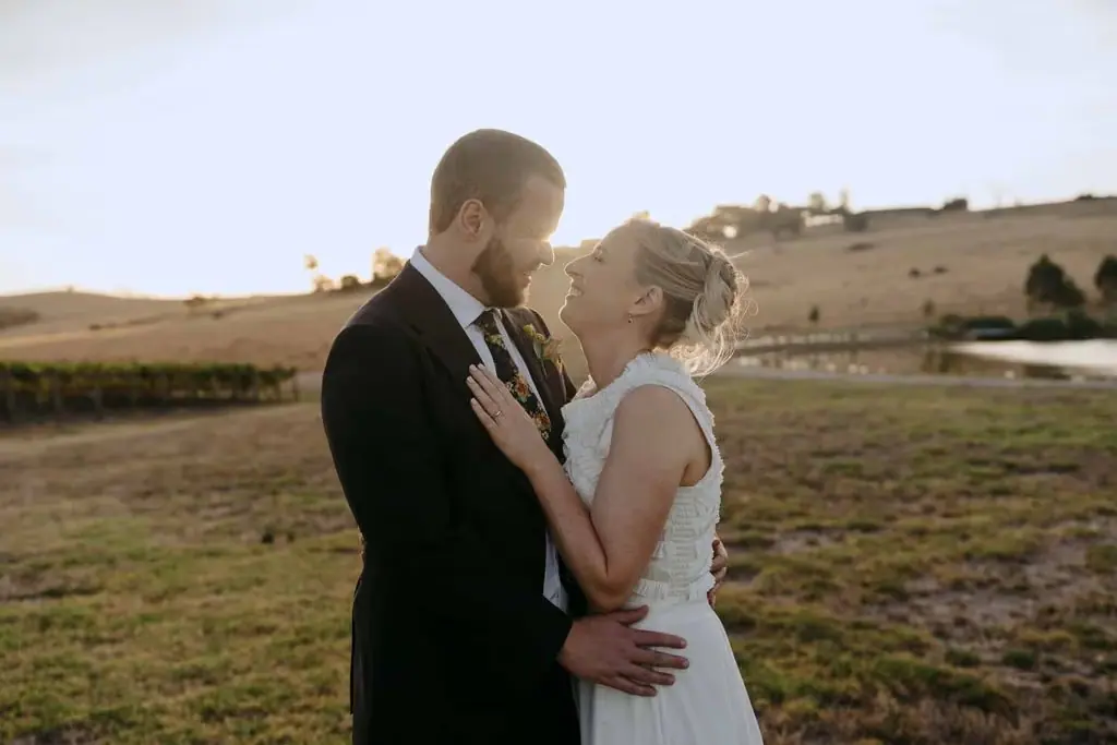 Couple touching foreheads in a dry field