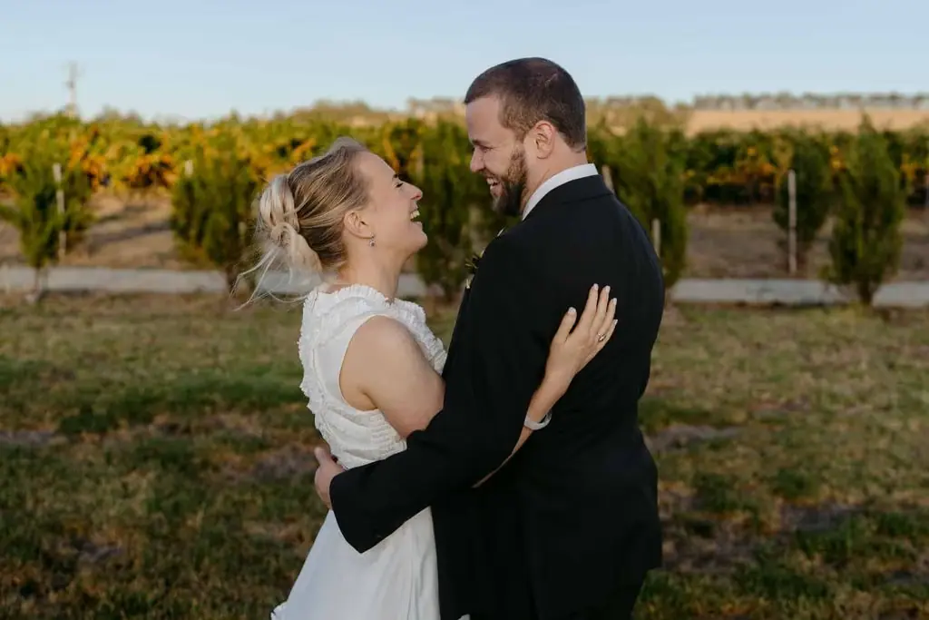 Couple laughing together among the vines