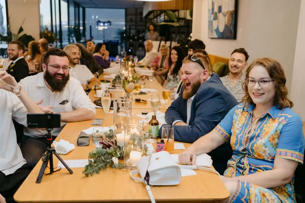 Guests smiling around long reception tables