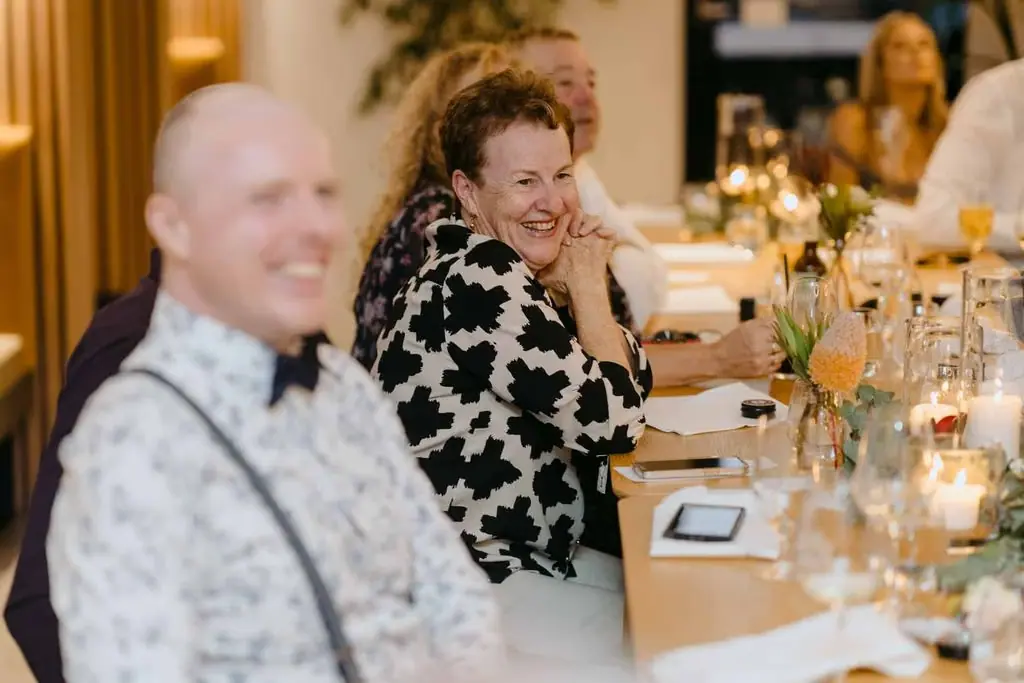 Guests laughing together at the reception table