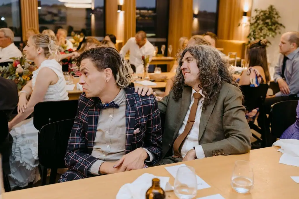 Two guests watching a reception speech