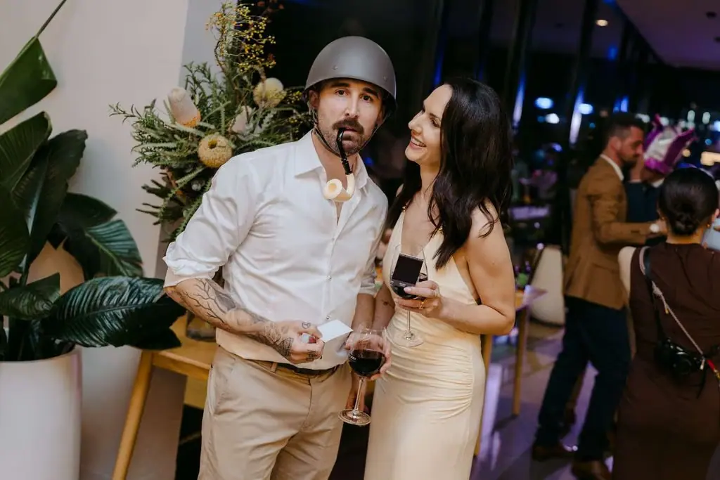 Two guests dancing, one wearing a bucket hat