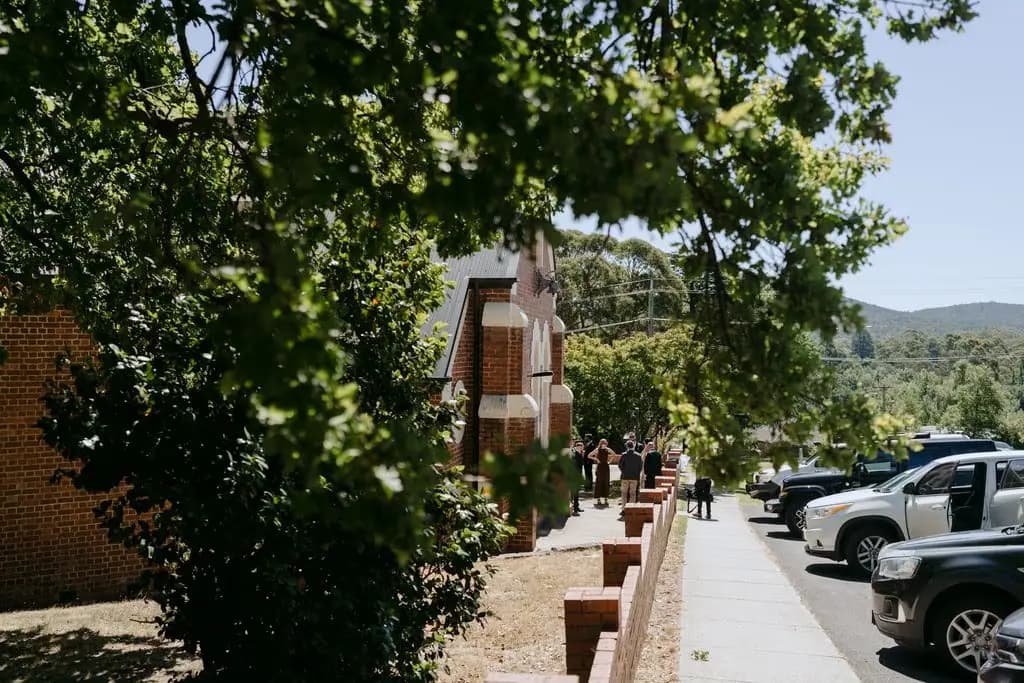 Tree-lined street outside a brick church