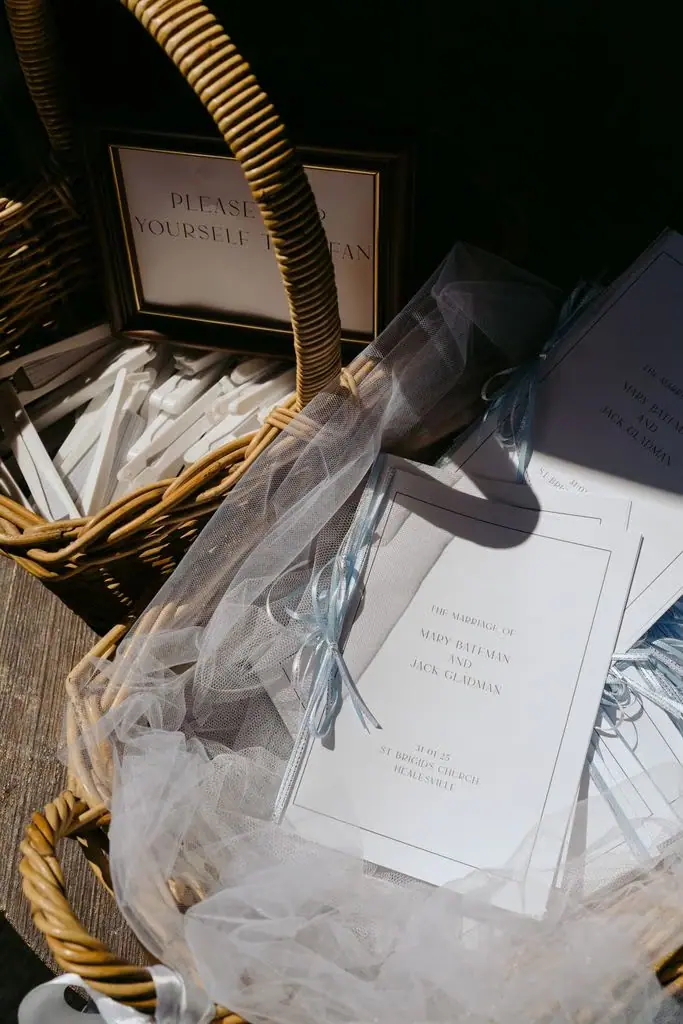 Ceremony booklets and pale fabric in a basket