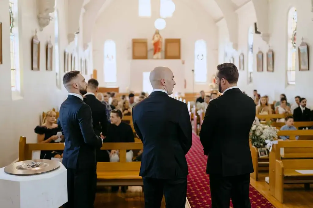 Groomsmen standing at the front of the church