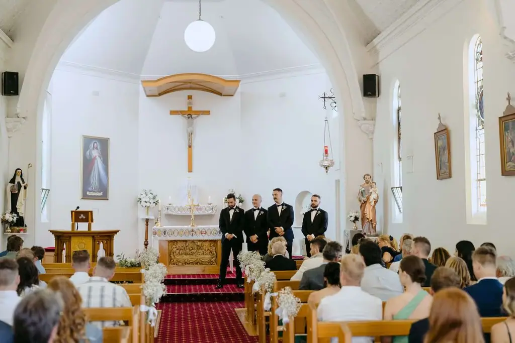 Wide view of guests seated for the church ceremony