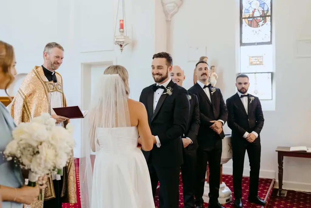 Couple smiling at each other during the church ceremony