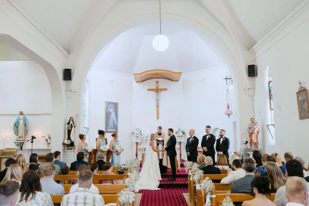 Wide view of the wedding ceremony inside the church
