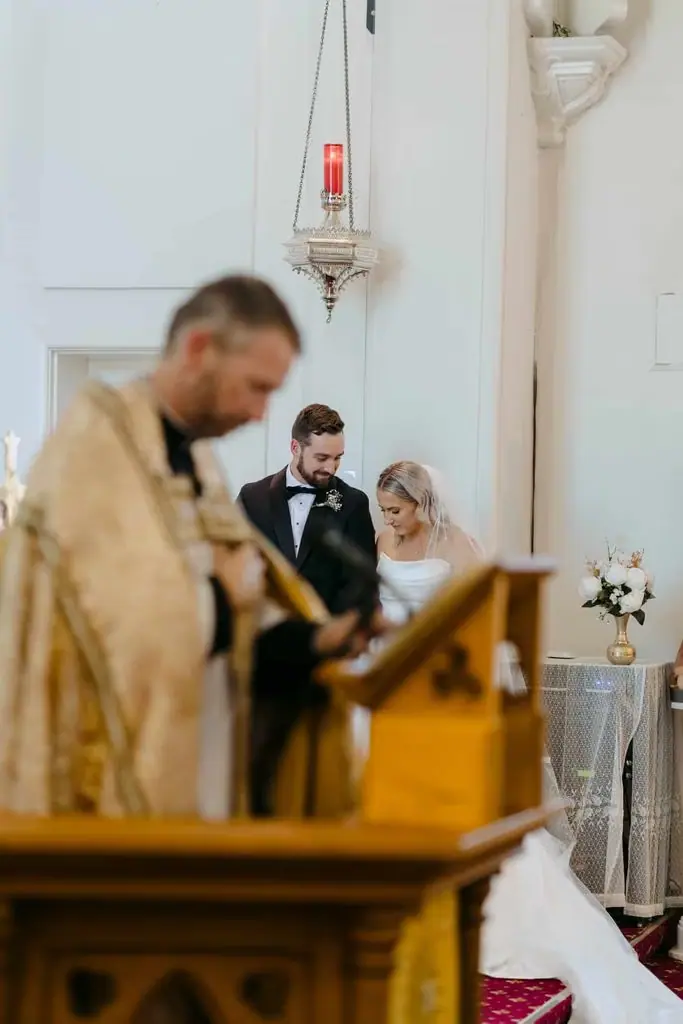 Priest reading during the wedding ceremony